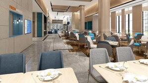 A modern restaurant interior with multiple dining tables and chairs, a visible menu board, and a counter area. - Holiday Inn Express Yixing (Wuxi)