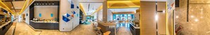 A modern hotel lobby with a reception desk, seating area, and a view of the lobby in the background. - Holiday Inn Express Yixing (Wuxi)