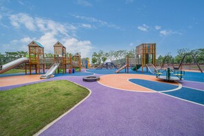 A playground with slides, climbing structures, and a circular play area. - Holiday Inn Express Yixing (Wuxi)