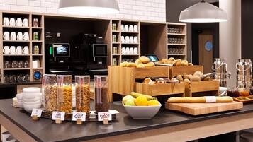 A breakfast buffet with various food items and beverages.