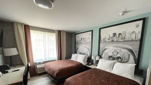 A hotel room with two beds, a desk, a chair, and a window with curtains. - Super 8 by Wyndham Brooklyn Williamsburg (Brooklyn)