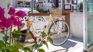 A sign for Princess Kinli Suite Hotel with a bicycle parked in front. - Princess Kinli Suites Hotel (Marmaris)