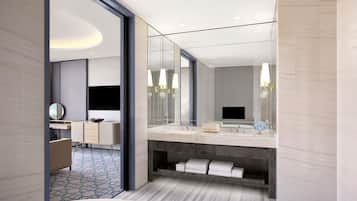 A modern bathroom with a large mirror, a bathtub, and a vanity with a sink.