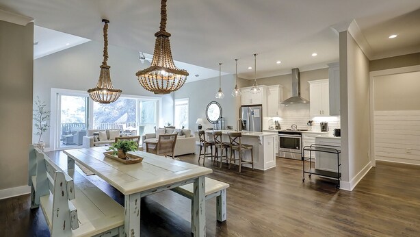 A spacious kitchen with modern appliances, a dining area with a large table, and a view of the outdoors. - 13 Starboard Tack - Beautiful oasis w/ private dock & Pool - Sleeps up to 17 (Hilton Head Island)