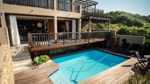 A modern two-story house with a wooden deck and a swimming pool. - 4 Dolphin views La Mercy (La Mercy)