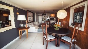A dining area with a round table, chairs, a chandelier, and a clock on the wall. - 4 Dolphin views La Mercy (La Mercy)