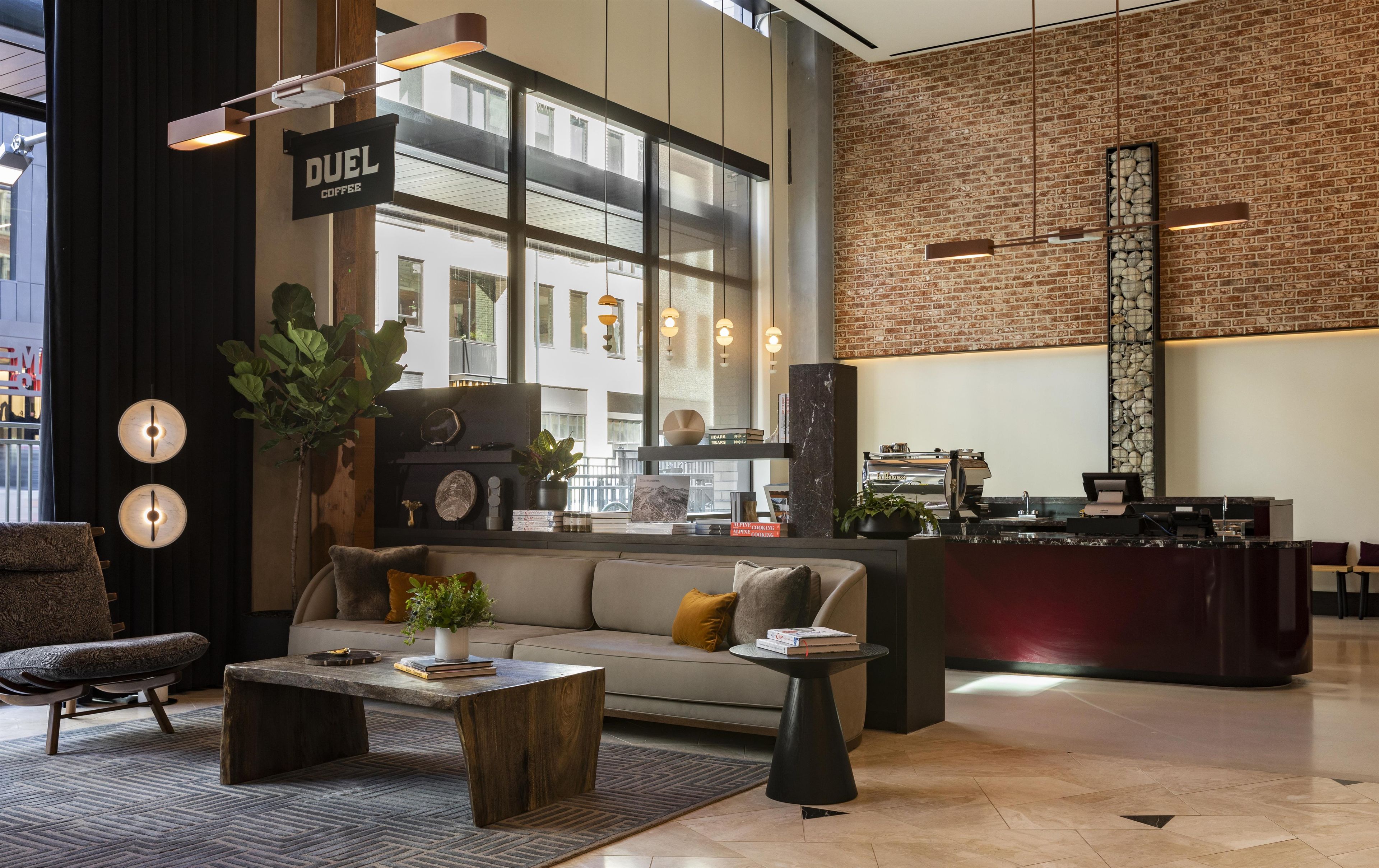 A modern lounge area with a sofa, coffee table, and a bar counter.