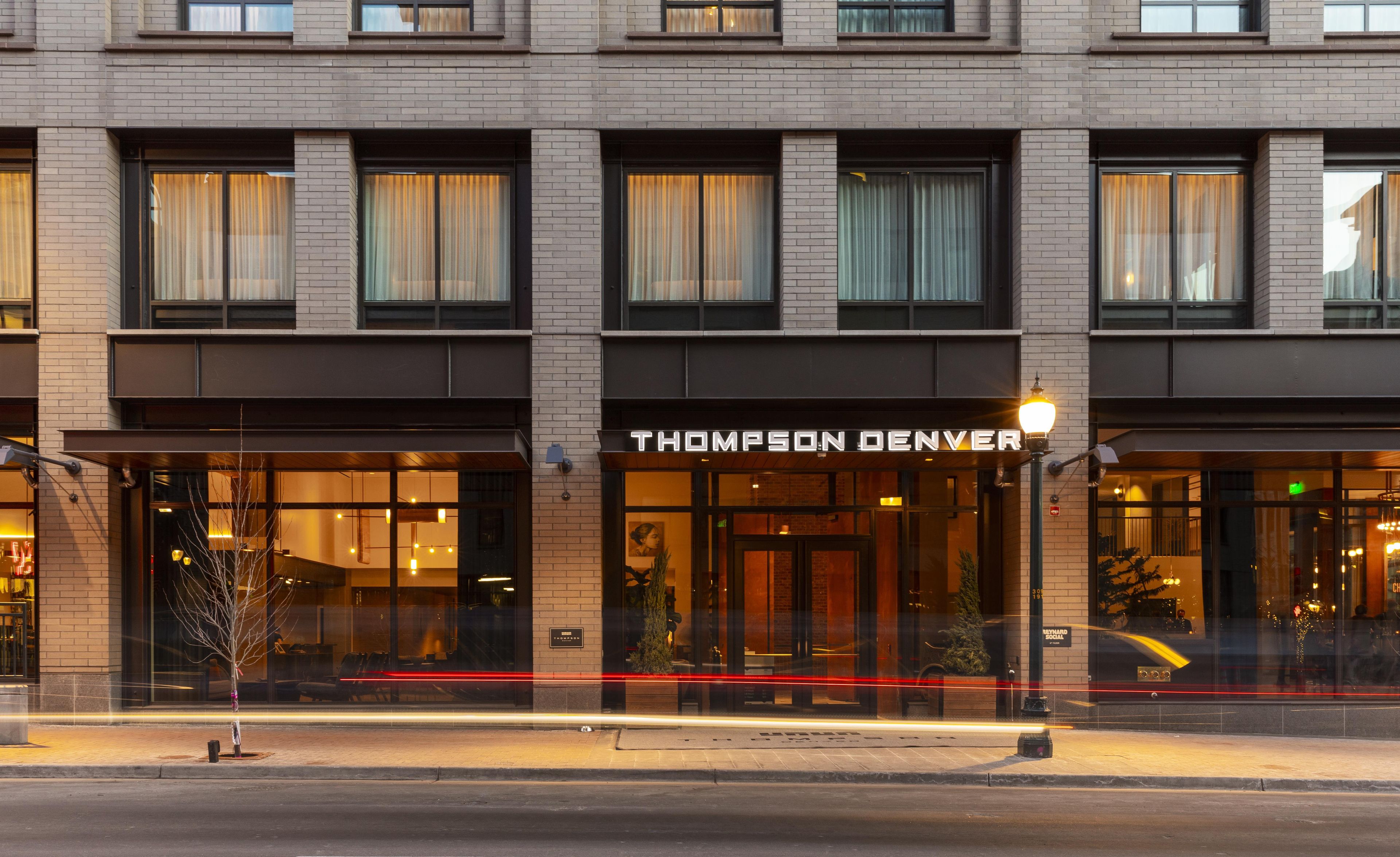 A hotel with a modern facade, large windows, and a prominent entrance.