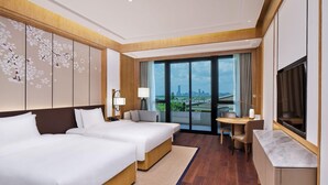 A hotel room with two beds, a desk, a TV, and a large window with a city view. - Hualuxe Suzhou Bay Hot Spring Resort, an IHG Hotel (Suzhou)