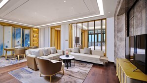 A modern living room with a sofa set, a coffee table, and a TV. - Hualuxe Suzhou Bay Hot Spring Resort, an IHG Hotel (Suzhou)