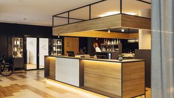 A modern reception area with a wooden counter, a bike in the background, and a glass display case.