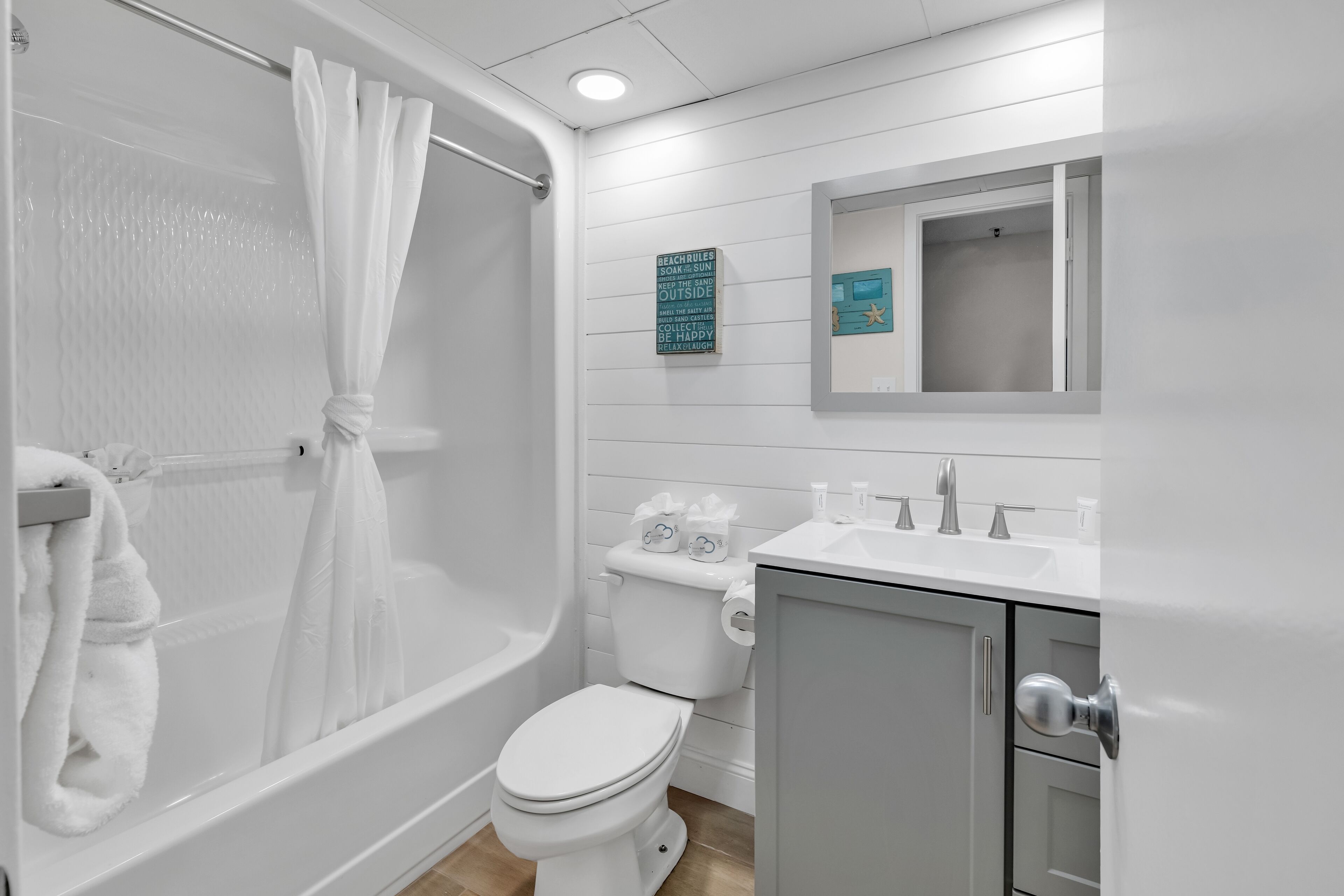 A bathroom with a bathtub, toilet, and sink.