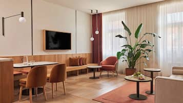 Deluxe Suite | Living room | 44-inch LED TV with satellite channels, TV