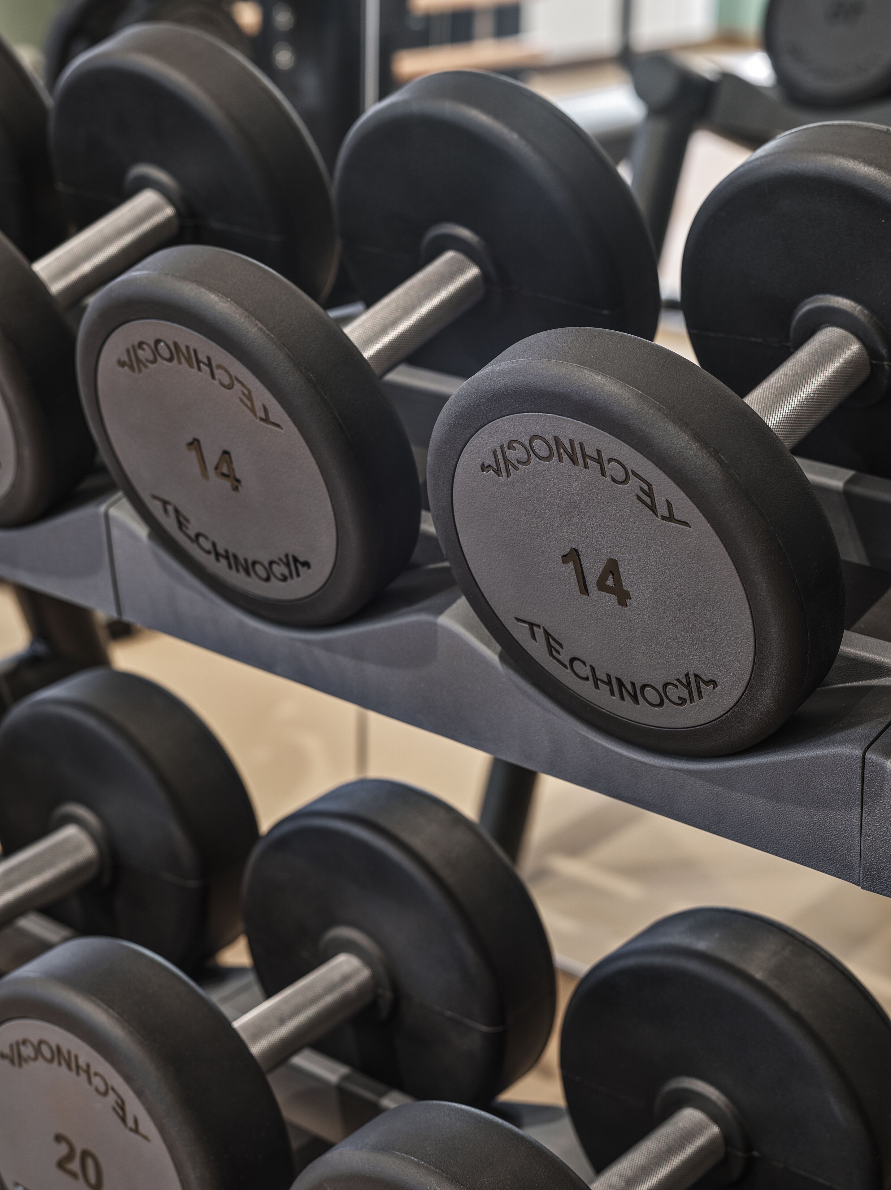 A rack of dumbbells with weight markings.