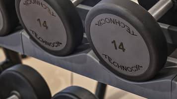 A rack of dumbbells with weight markings.
