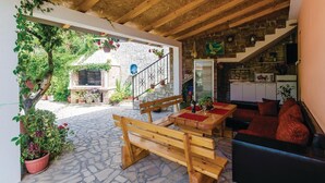A cozy interior with a stone fireplace, wooden furniture, and a staircase leading to a kitchen. - Stunning Home in Herceg Novi With 1 Bedrooms and Wifi (Baosici)