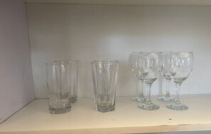 Four clear glass wine glasses on a shelf. - Nigus House Ikoyi - 2 bedrooms Penthouse (Lagos)