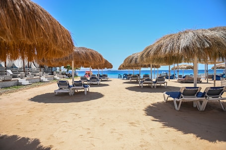 On the beach, sun-loungers, beach umbrellas, beach towels. AJIRA Boutique Hotel Hurghada Marina