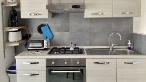 A modern kitchen with a built-in oven, a gas stove, a sink, and a toaster. - Peter's nest (Verano Brianza)