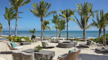 On the beach, white sand, beach cabanas, sun-loungers