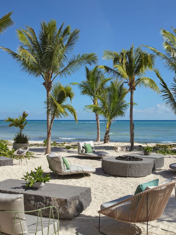 On the beach, white sand, beach cabanas, sun loungers