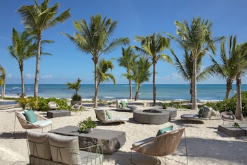 On the beach, white sand, beach cabanas, sun loungers
