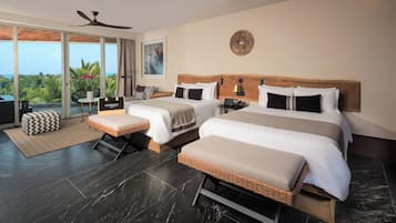 A hotel room with two beds, a balcony, a ceiling fan, and a view of the ocean.