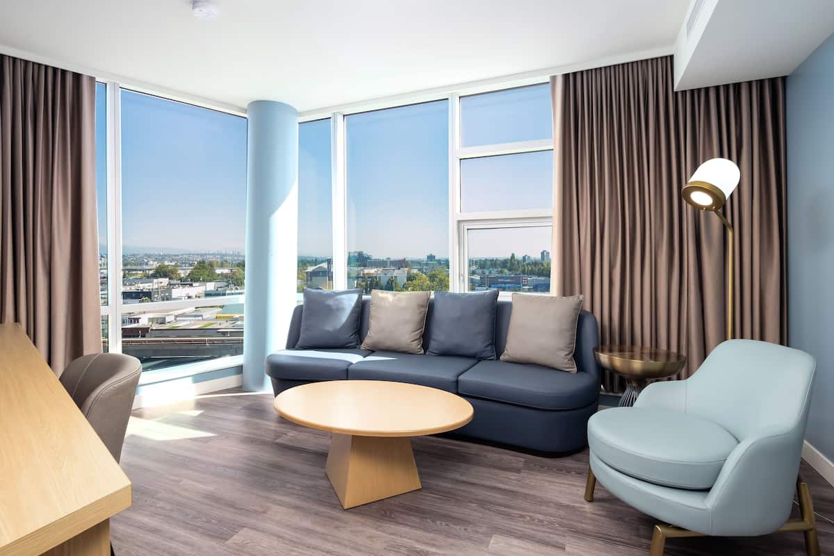 Deluxe Suite, 1 King Bed, Corner | Living area | 55-inch Smart TV with digital channels, TV, Netflix
