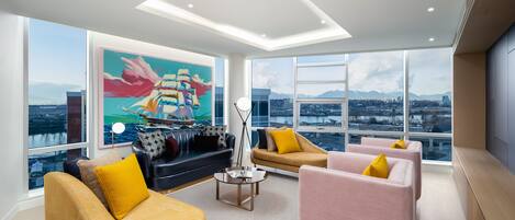 Una sala de estar moderna con ventanas amplias, vistas a la ciudad y muebles contemporáneos.