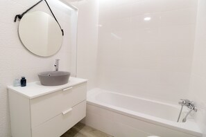 Bathtub, hair dryer, soap, shampoo