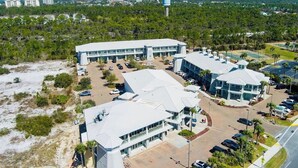 A large, modern building with multiple parking lots and a central courtyard. - Beach Retreat in Perdido Key, Florida (Pensacola)