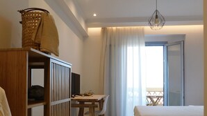 A bedroom with a bed, a wooden desk, a chair, and a wardrobe. - Orea Superior Rooms (Zakynthos)