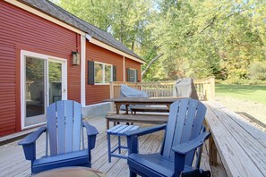 A wooden deck with Adirondack chairs, a picnic table, and a barbecue grill. - Renovated Farmhouse < 1 Mile to Okemo Mountain! (Ludlow)