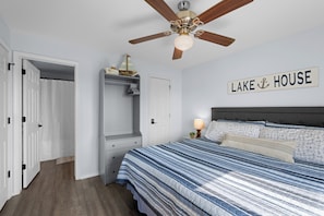 A bedroom with a bed, a ceiling fan, a wardrobe, and a sign that reads "LAKE HOUSE". - Waterfront Pool! Near SDC - Step-Free Access! (Kimberling City)