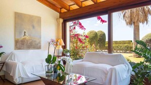 A cozy living room with a glass coffee table, white sofas, and a painting on the wall. - Spectacular finca with pool in the outskirts of Inca (Inca)