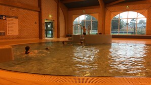 An indoor swimming pool with tiled walls and large windows. - 3 Bed Luxury Mobile Home Hoburne Park Christchurch (Christchurch)