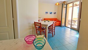 A dining area with a table, chairs, and colorful bowls.