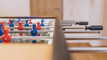 A foosball table with red and blue player figures.