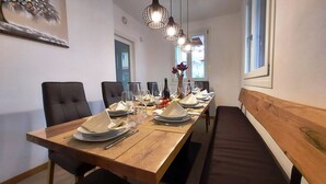 A long dining table set with plates, cutlery, and glasses, flanked by chairs and a bench. - Villa Massimiliano, with private heated pool and garden (Solarolo)