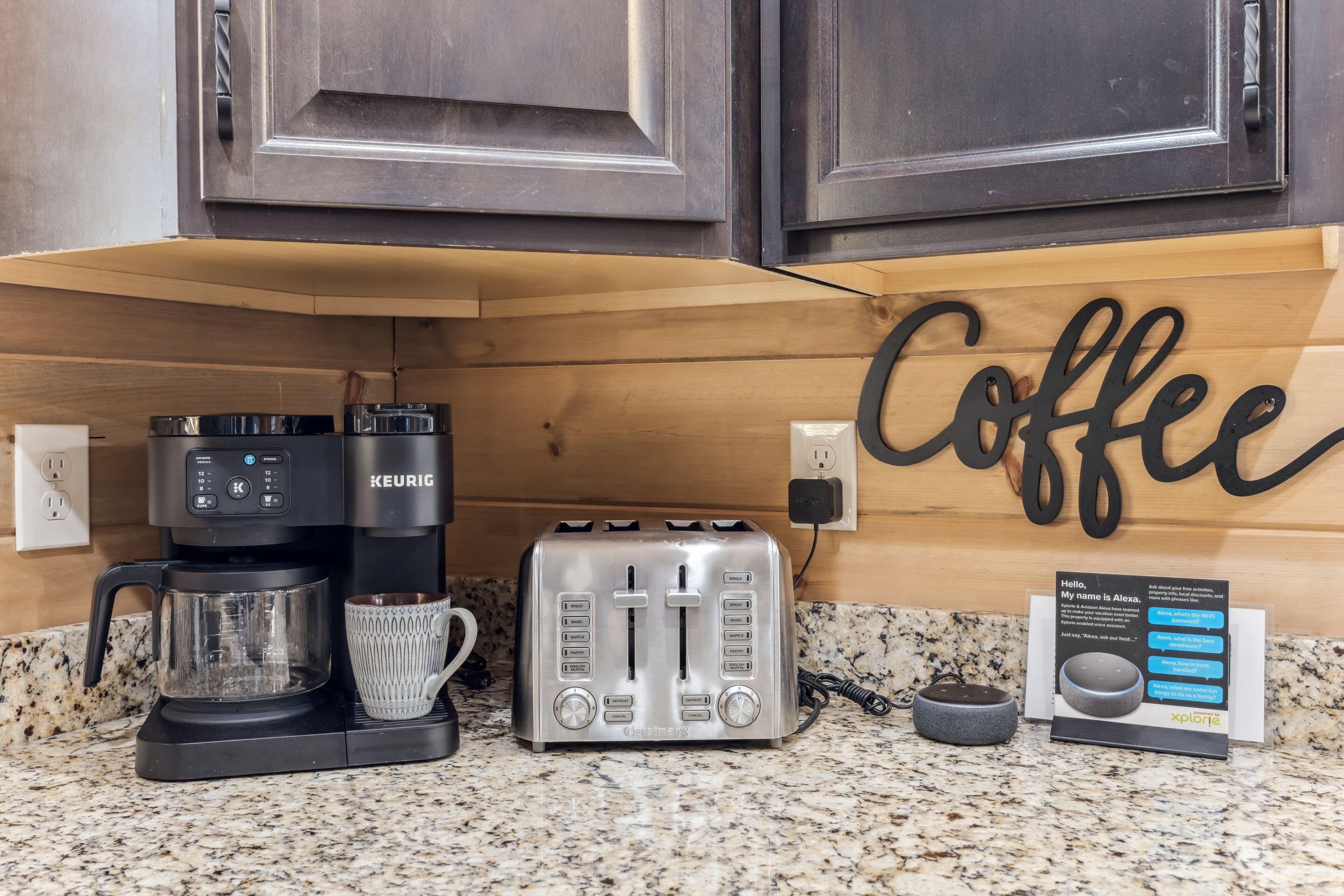 A kitchen counter with a coffee maker, toaster, and a coffee mug.