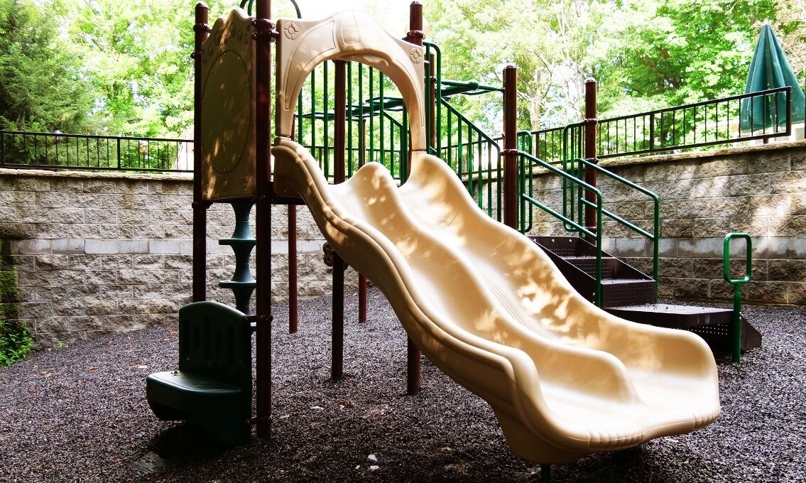 A playground with a slide and climbing structure.