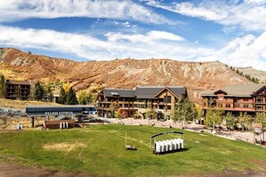 A lodge with a ski lift, surrounded by mountains and a clear sky. - Snowmass 2BR Getaway Pool, Hot Tub & Ski Access - D2 by RedAwning (Snowmass Village)