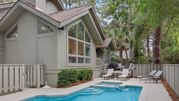 A residential property with a swimming pool, outdoor seating, and a covered patio area. - Direct Beach Path & Pool Near The Salty Dog Cafe (Hilton Head Island)