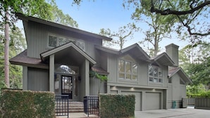 A two-story house with a front porch, a garage, and a well-maintained lawn. - Direct Beach Path & Pool Near The Salty Dog Cafe (Hilton Head Island)