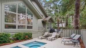A backyard with a swimming pool, lounge chairs, and a covered patio area. - Direct Beach Path & Pool Near The Salty Dog Cafe (Hilton Head Island)