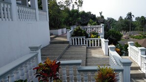 A staircase with white balustrades leading to a building entrance. - Villa en Alquiler con Vista al mar (Cabrera)