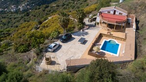 A villa with a swimming pool, a covered patio, and a view of the surrounding hilly landscape. - Villa Torrox Family by Solset (Torrox)