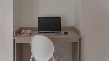 A workspace with a laptop, a book, and a mouse on a desk.