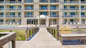 A multi-story hotel with a pool area, wooden deck, and a gazebo. - SunTime at the BEACH! Updated 2nd Floor Unit! GREAT Views of 2 Pools and Gulf! (Dauphin Island)
