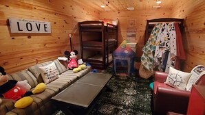 A cozy room with a bunk bed, a couch with plush toys, and a sign that reads "LOVE". - A remote getaway ... Enjoy nature, have fun and embrace relaxation! (windsor)